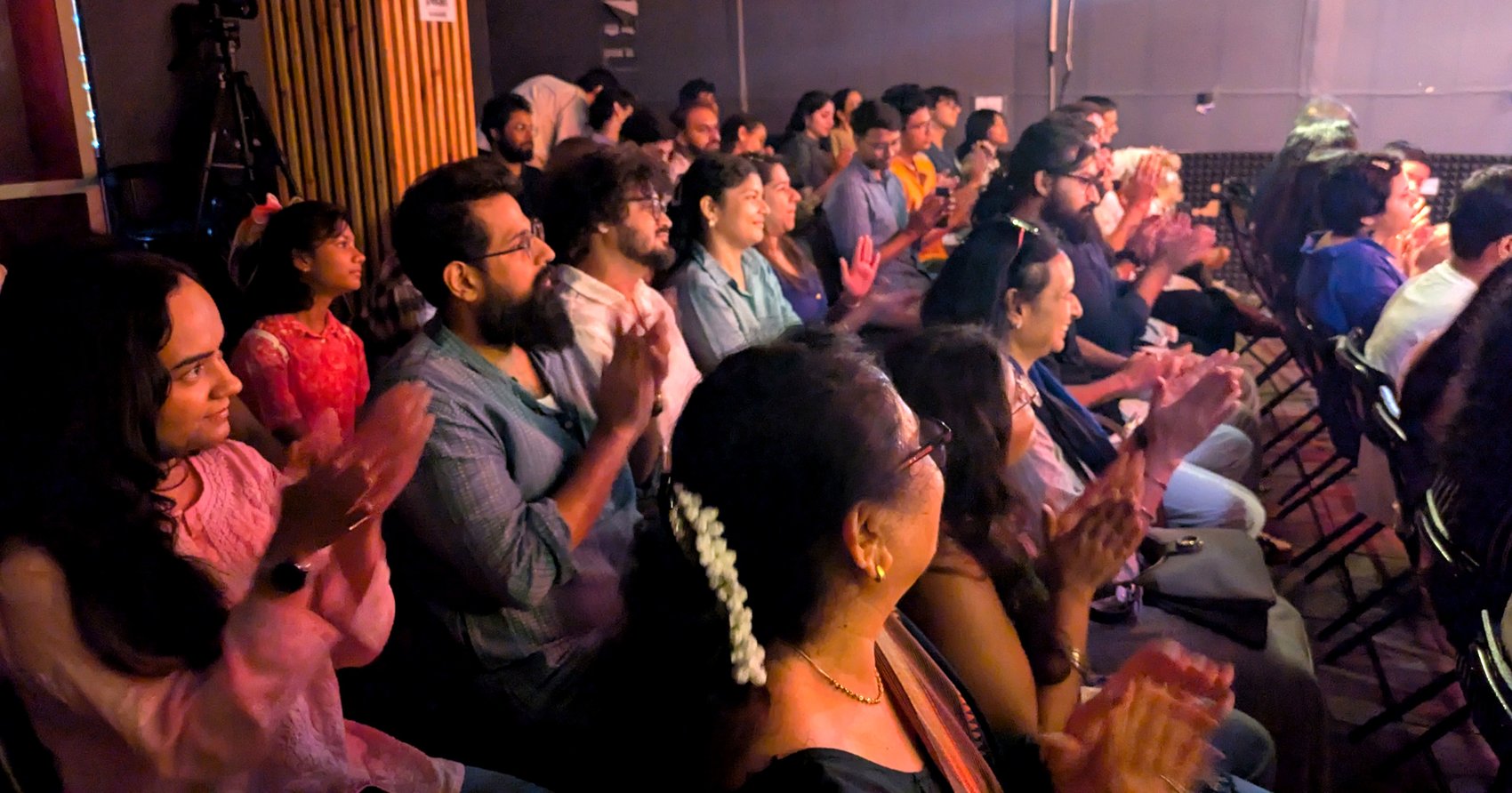 Audience applauding at a Tarang open mic evening